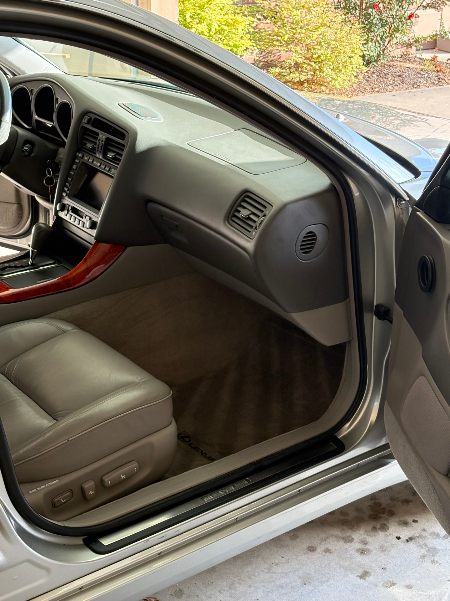 Clean Lexus passenger footwell, dash and door panel after interior detailing