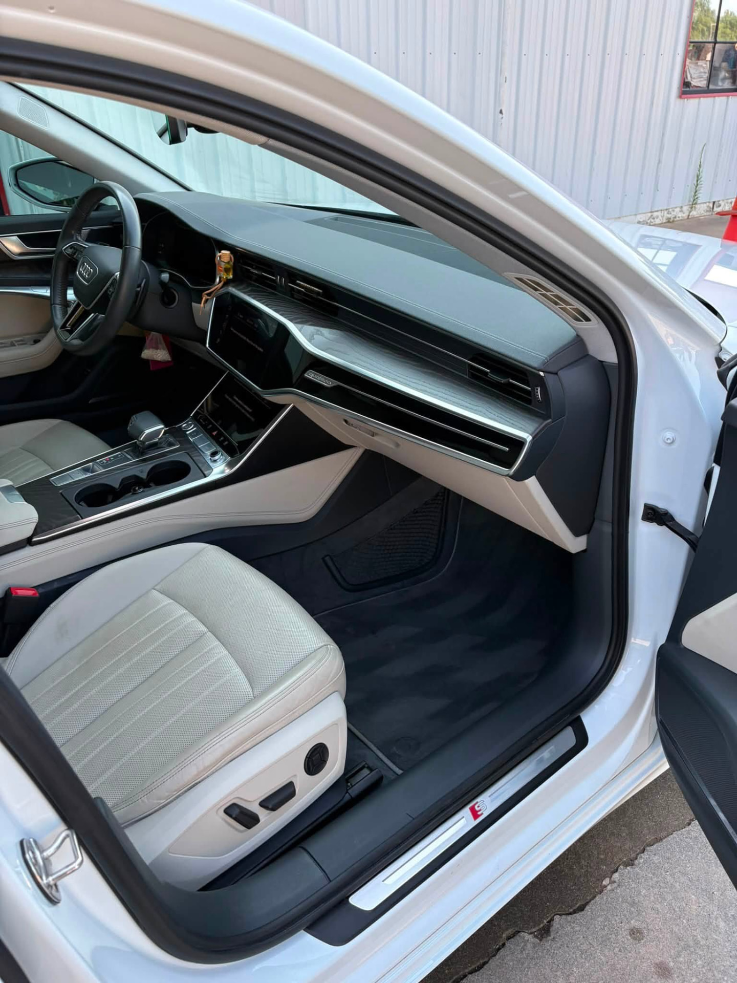 Audi A6 passenger side after detailing, with dust-free dash, clean console and vacuumed carpet