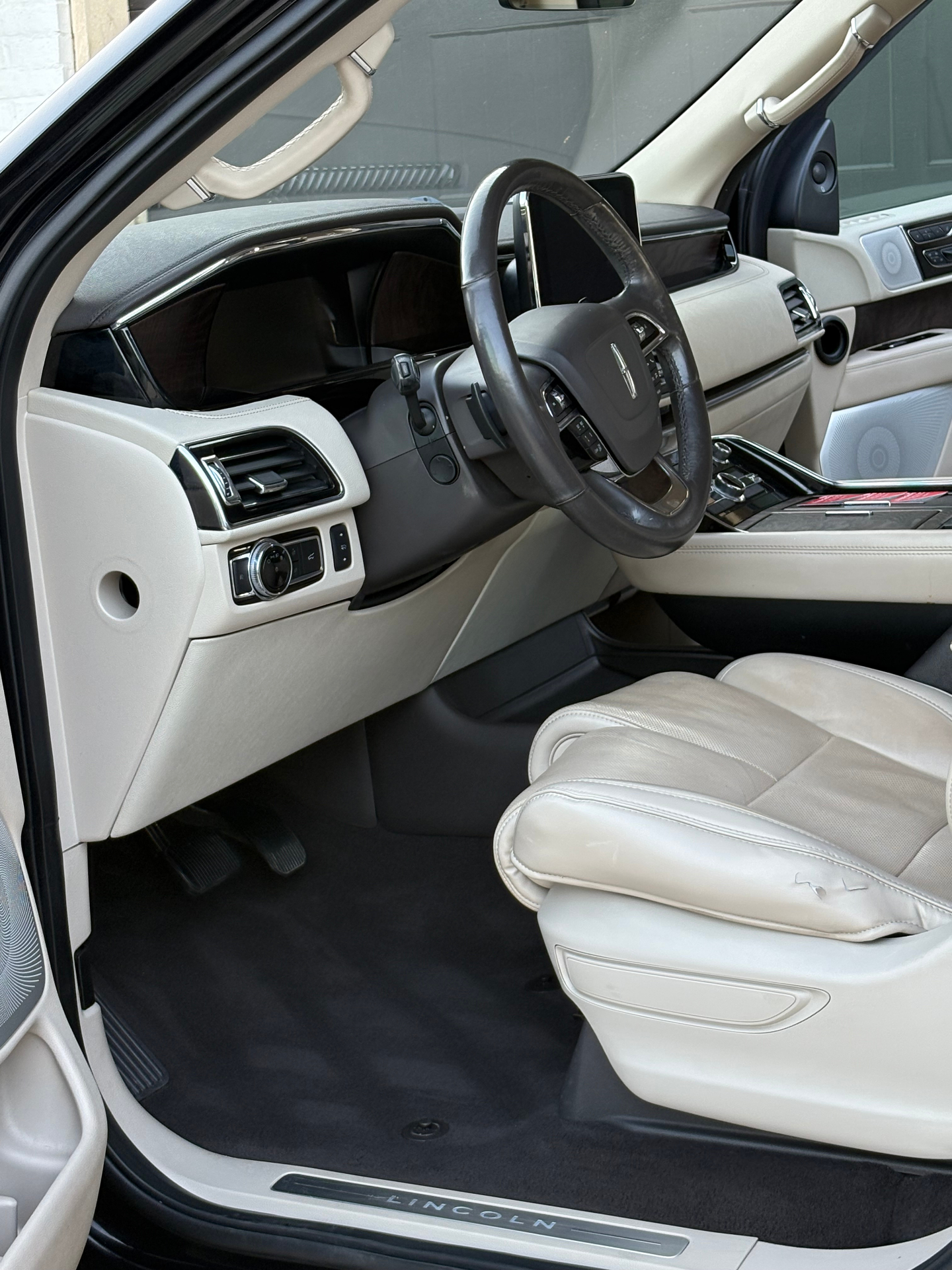 Cleaned and conditioned white leather Lincoln Navigator front interior