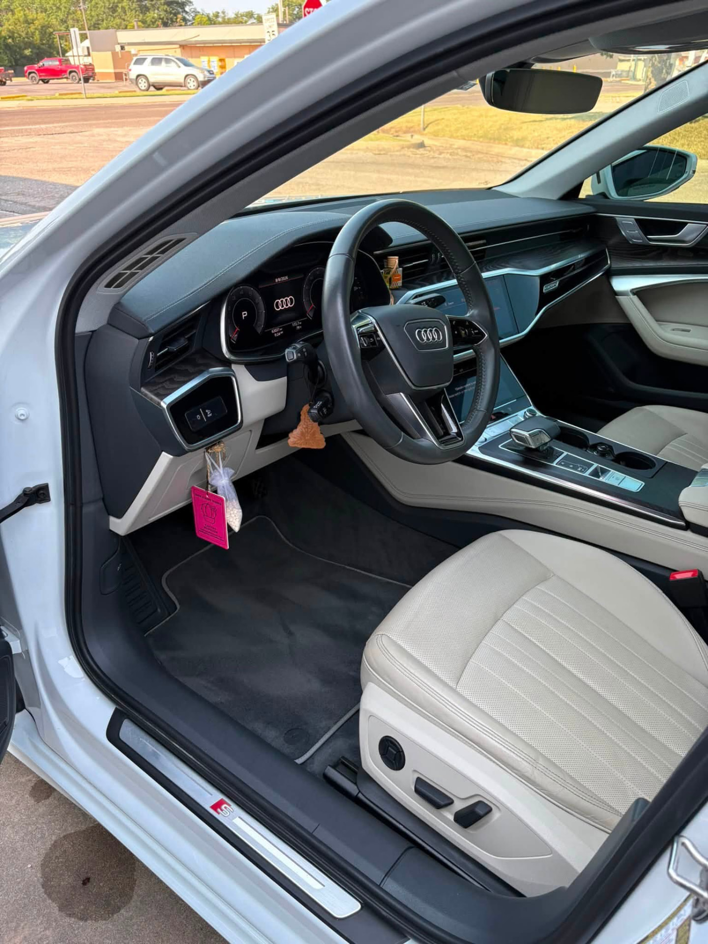 Audi A6 driver area after an interior detail, with clean white leather seat, dash and floor mat