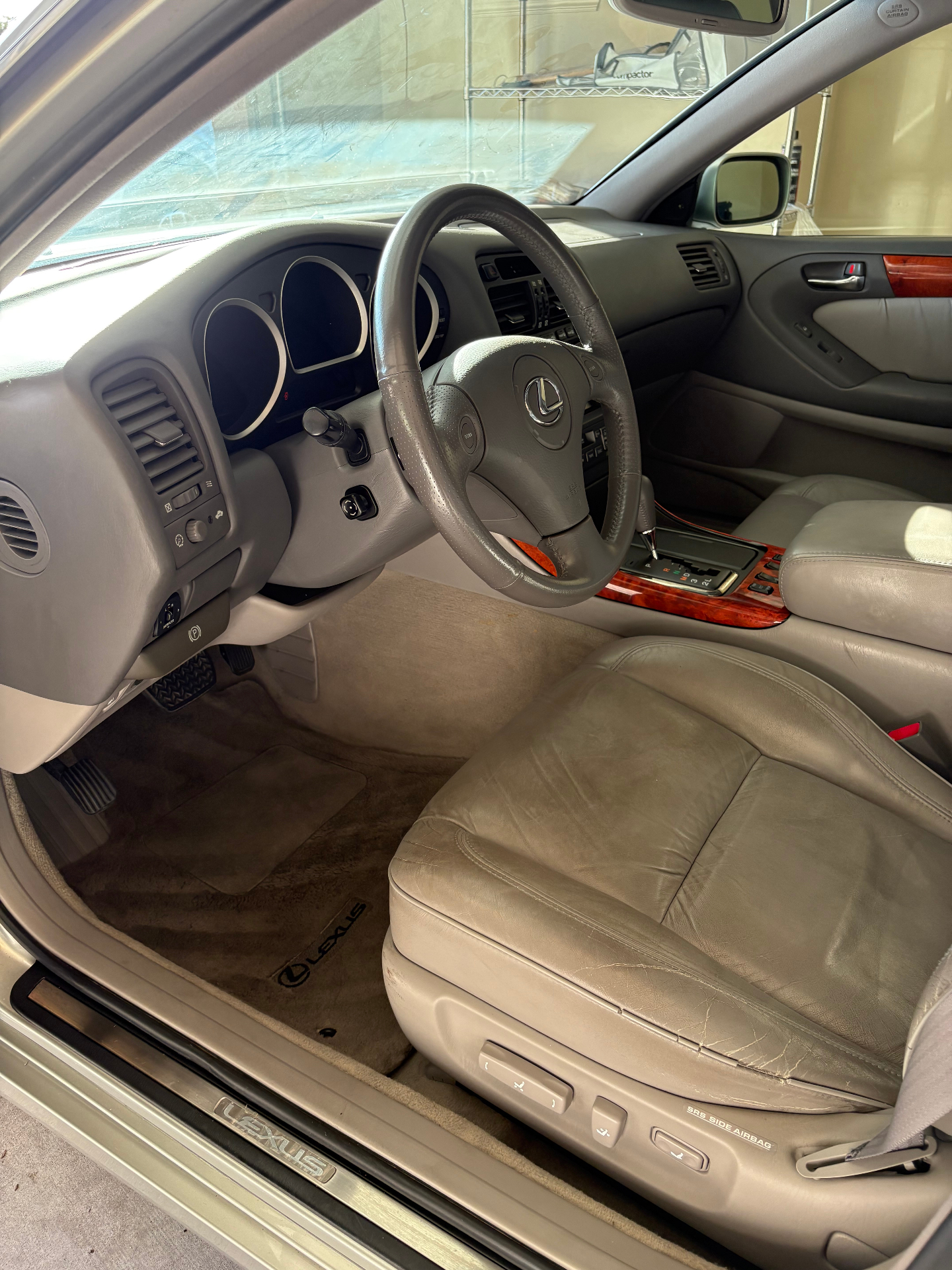 Detailed Lexus driver interior with conditioned leather seat and polished wood trim