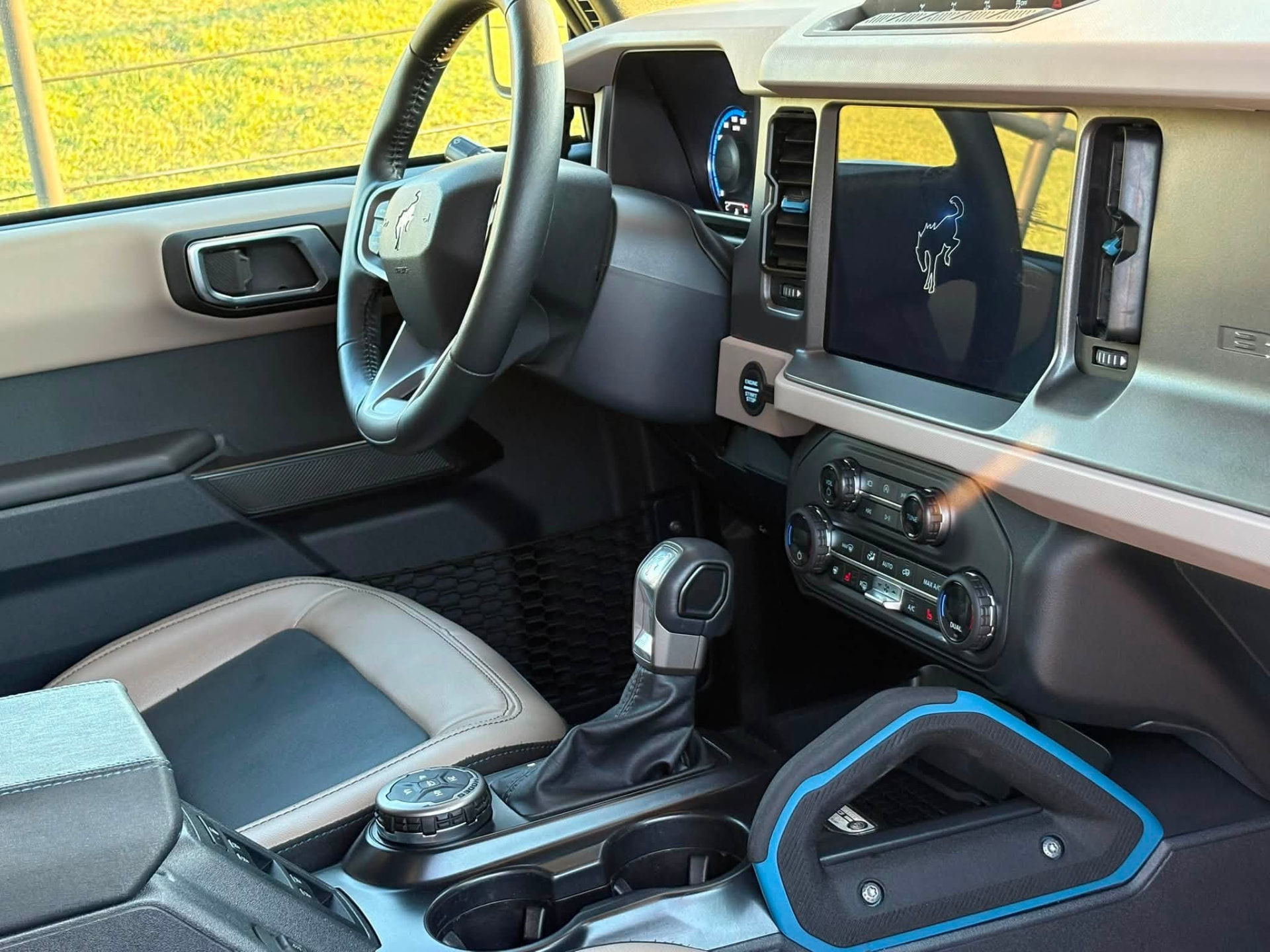 Ford Bronco front cabin after an interior detail, with clean dash, screen, console and floor liner