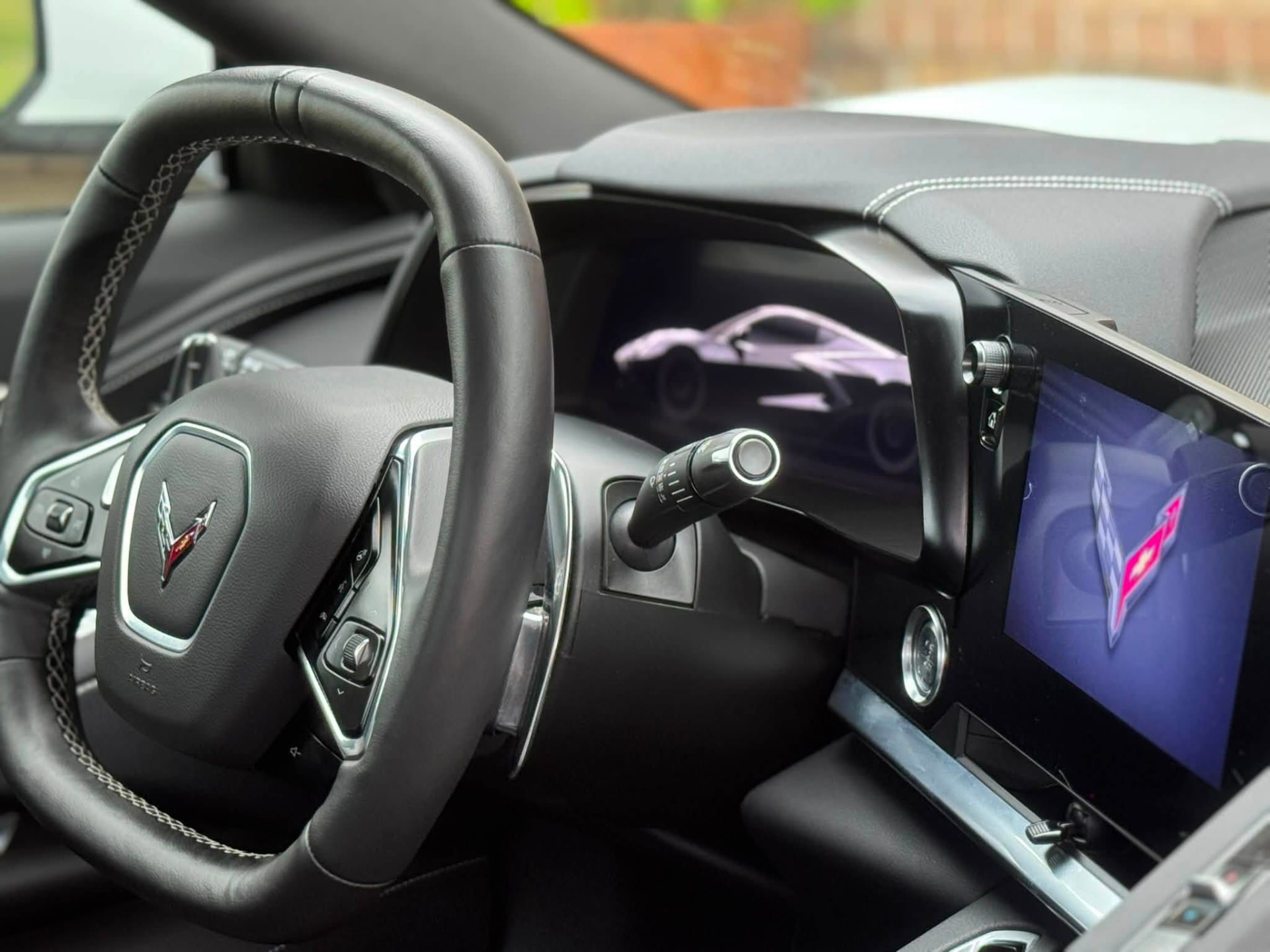 Detailed C8 Corvette steering wheel, dash and screens with no dust after an interior detail